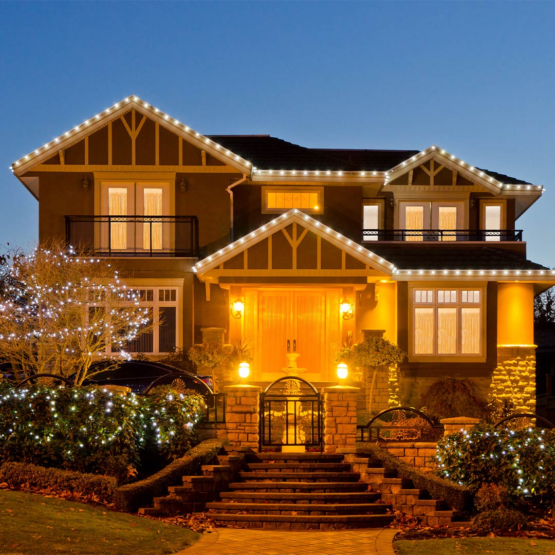 exterior of two story home with holdiay lighting