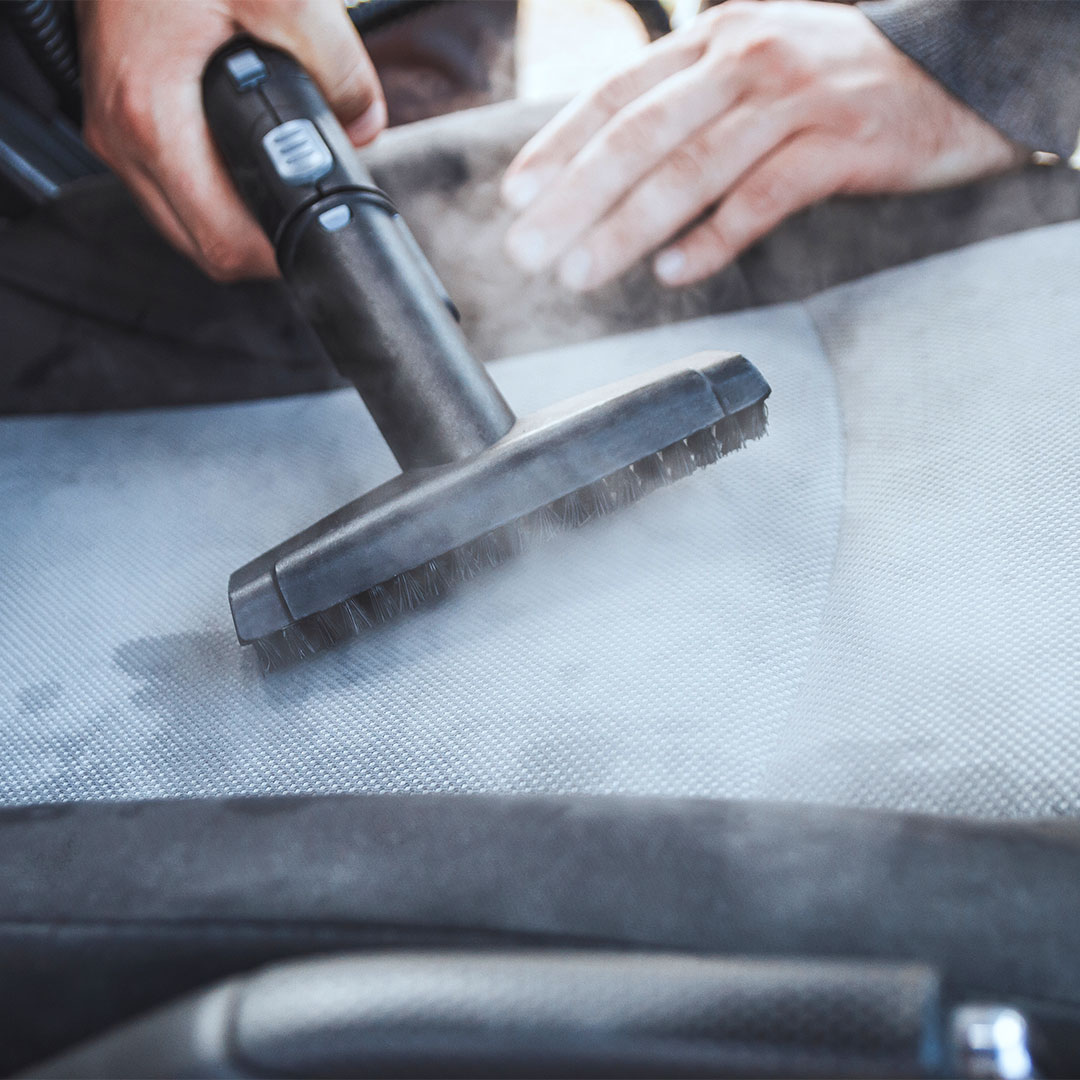 Steam cleaning cloth car seats during interior detailing