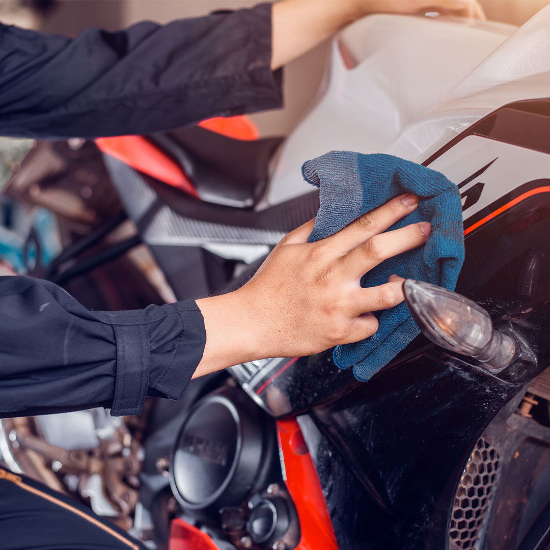 Motorcycle exterior detailing with microfiber towel